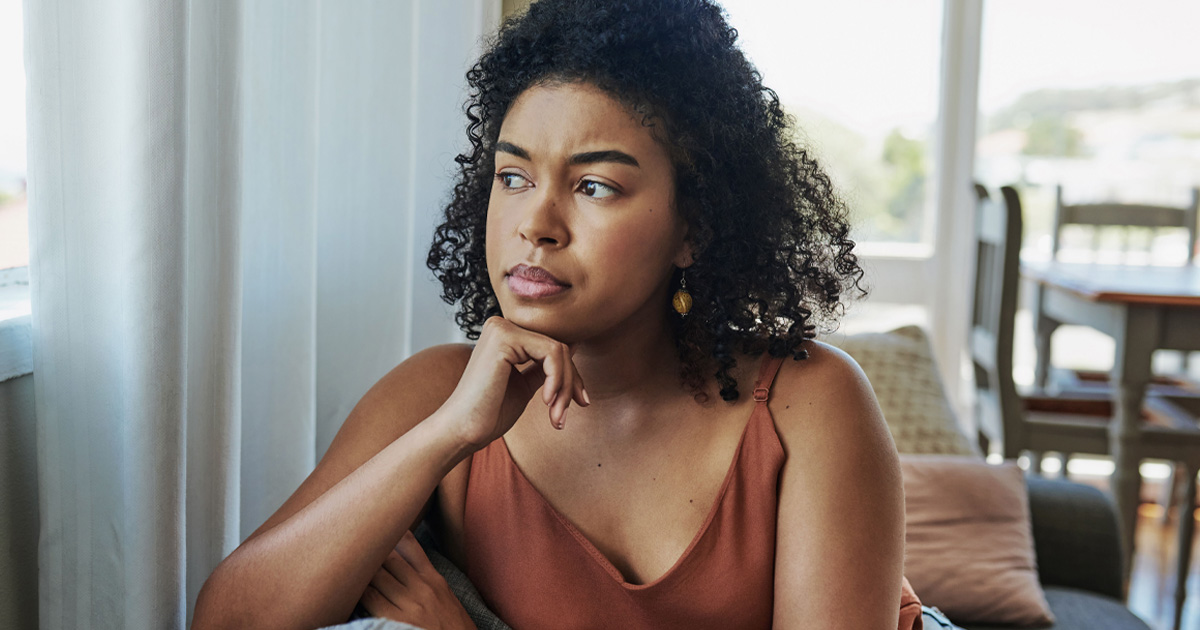 Woman of color looking into the distance